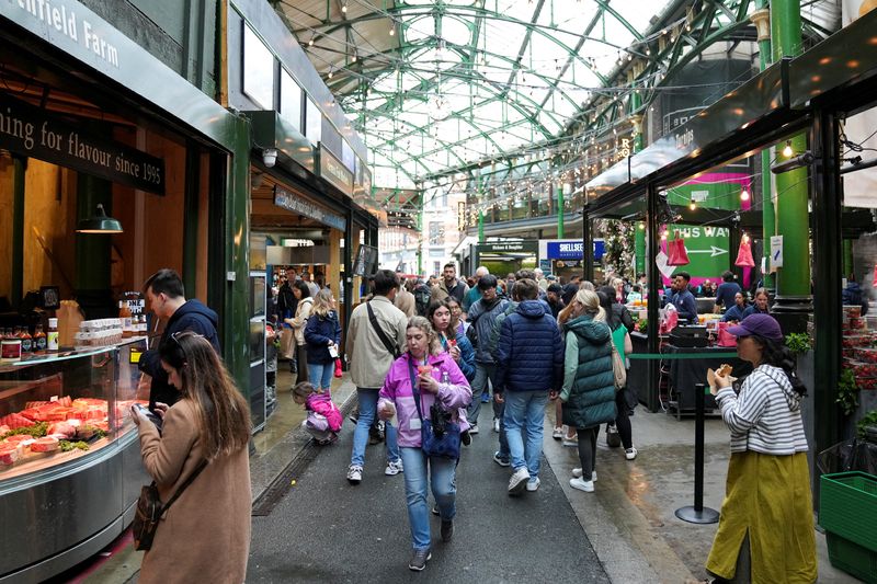 People walk past food stands and market stalls in a Borough Market in London, Britain May 22, 2024. REUTERS/Maja Smiejkowska
