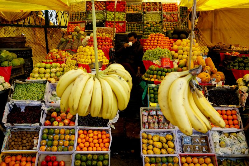 FILE PHOTO: Muhammad Saleem, 48, a Kashmiri roadside vendor, sells fruits in a market area in Srinagar, Indian Kashmir, February 6, 2026. REUTERS/Sharafat Ali/File Photo