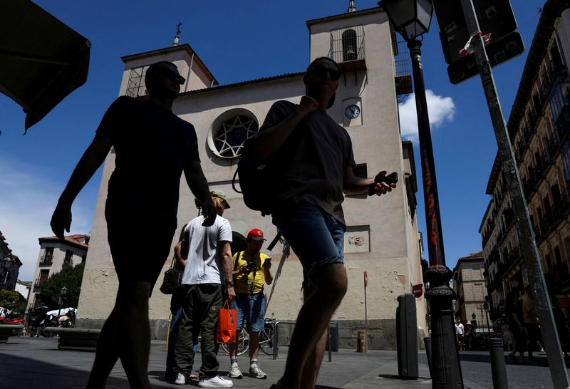 FILE PHOTO: People walk in Madrid, Spain, July 12, 2025. REUTERS/Violeta Santos Moura/File Photo