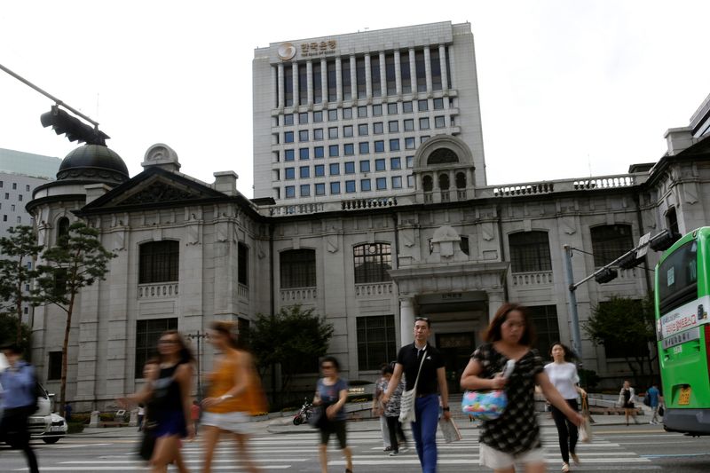 People walk on a zebra crossing in front of the buliding of Bank of Korea in Seoul, South Korea, July 14, 2016.  REUTERS/Kim Hong-Ji