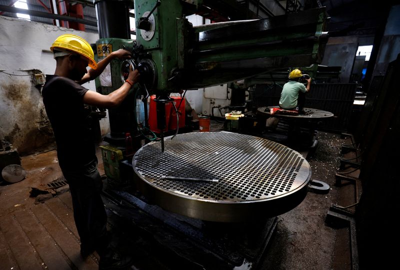FILE PHOTO: A worker makes a metal filter plate inside an industrial manufacturing unit on the outskirts of Ahmedabad, India, July 23, 2024. REUTERS/Amit Dave/File Photo