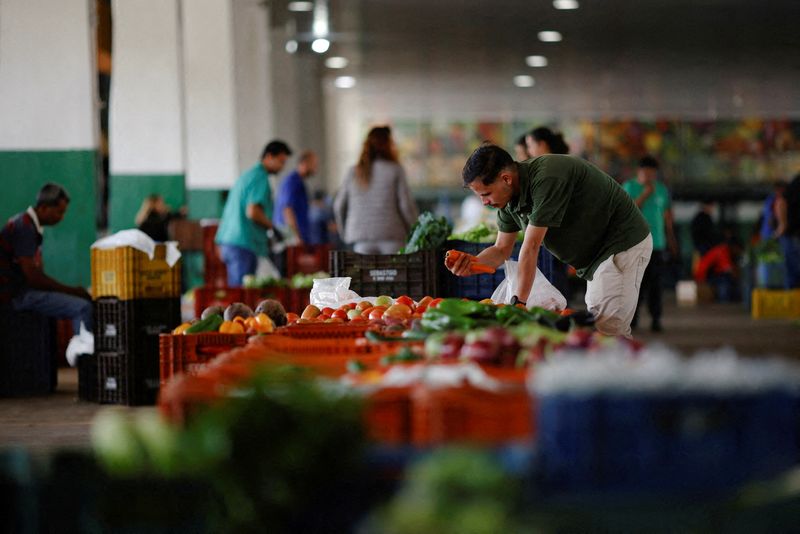 FILE PHOTO: A salesman is seen at his vegetable stand at the supply centre (CEASA) in Brasilia, Brazil May 9, 2023. REUTERS/Adriano Machado/File Photo