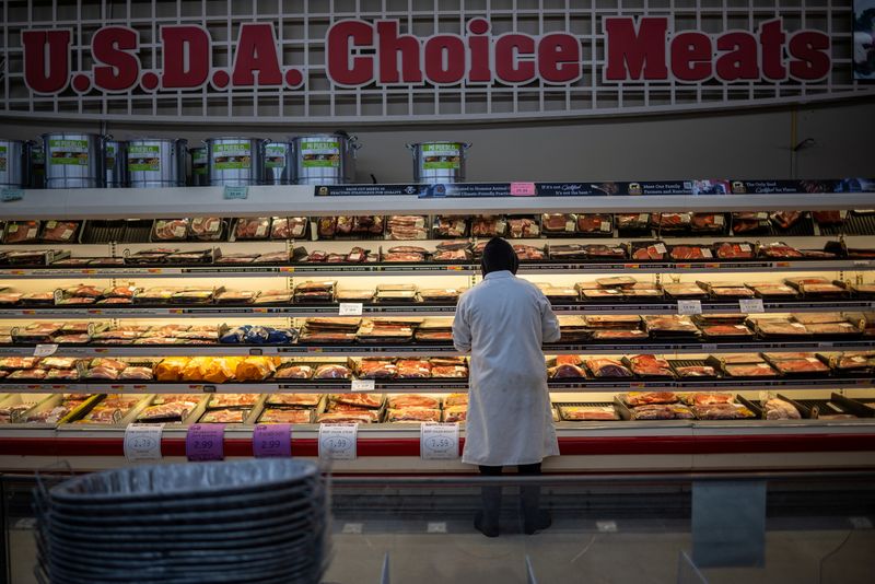An employee stands at the meat section of a local supermarket located near a Tyson Foods meatpacking plant (not pictured), which is scheduled to shut down in the coming days, in Lexington, Nebraska, U.S. January 14, 2026. REUTERS/Carlos Barria/File Photo