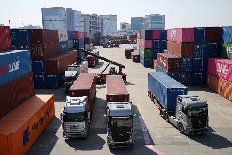 FILE PHOTO: Trucks transport shipping containers at the Uiwang ICD Terminal in Uiwang, South Korea, March 13, 2026.   REUTERS/Kim Hong-Ji/File Photo
