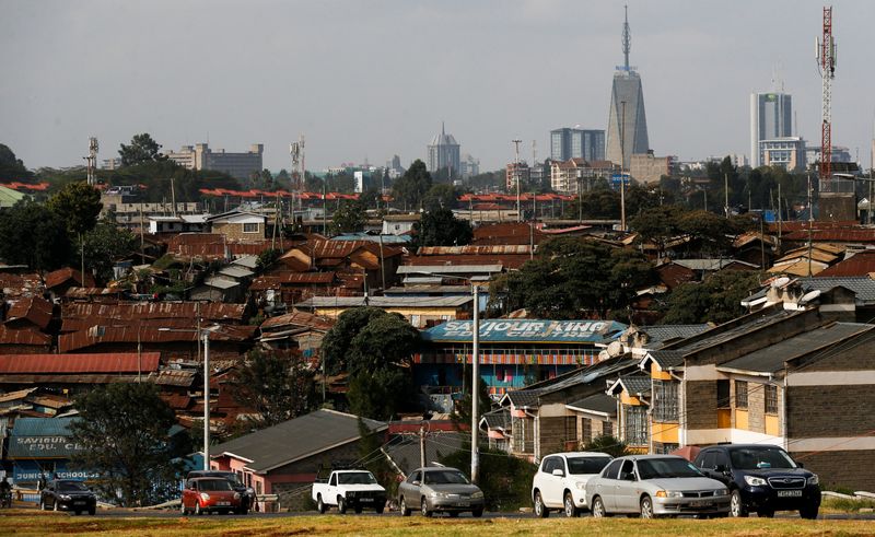 Motorists drive past Kibera settlement with the backdrop of the skyline of Upper-Hill district of Nairobi, Kenya June 23, 2025. REUTERS/Thomas Mukoya