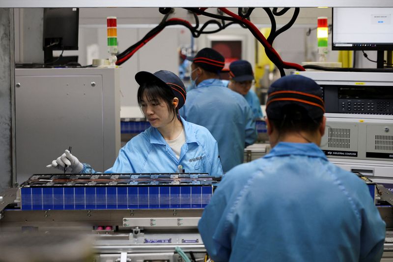 Employees work on a battery assembly line at the factory of Leapenergy, a unit of Leapmotor, during an organised media tour in Huzhou, Zhejiang province, China, April 26, 2026.  REUTERS/Go Nakamura