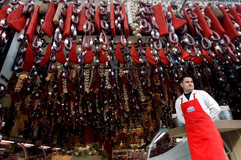 A grocer stands outside his shop in Athens, Greece November 8, 2011.   REUTERS/John Kolesidis/File Photo
