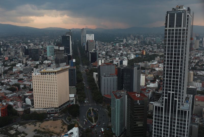 A view of Mexico city's skyline during a sunset as cars are pictured along Reforma Avenue in Mexico City, Mexico in this picture taken through glass in a building, May 24, 2023. REUTERS/Henry Romero