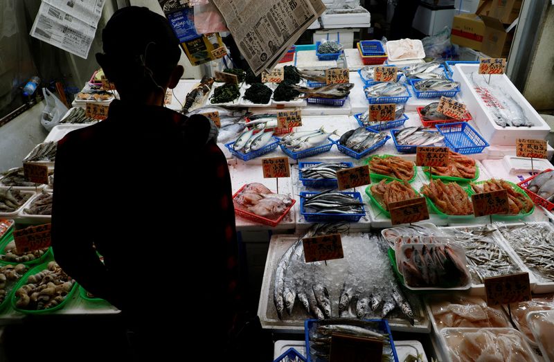 A customer looks around seafood at a shop in Tokyo, Japan November 19, 2025.  REUTERS/Kim Kyung-Hoon