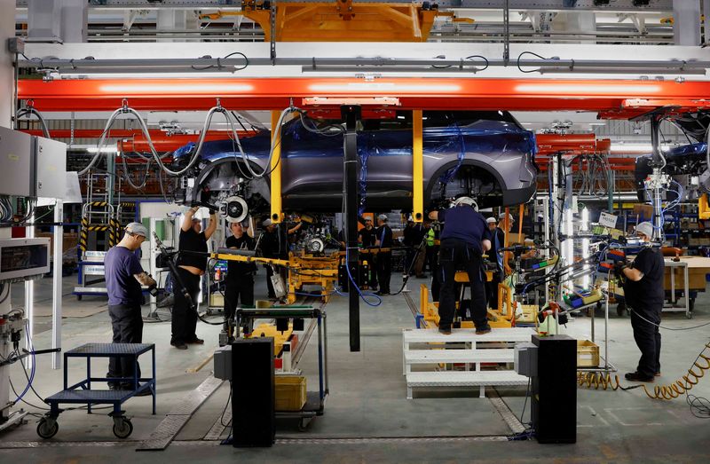 FILE PHOTO: Ebro Automotive's staff work in a car assembly line at their factory in Zona Franca in Barcelona, Spain November 14, 2024. REUTERS/ Albert Gea/File Photo