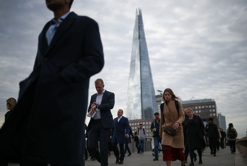 People walk over London Bridge towards the City of London financial district during rush hour in London, Britain, October 3, 2022. REUTERS/Henry Nicholls