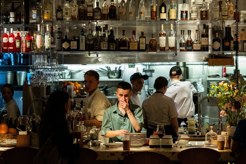 Employees work in the open kitchen of a restaurant in the Patriarch's Ponds neighbourhood in central Moscow, Russia July 11, 2025. REUTERS/Maxim Shemetov