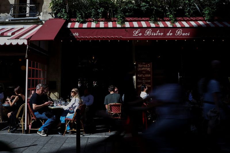 People sit at a restaurant on a sunny spring day in Paris, France, April 25, 2026. REUTERS/Sarah Meyssonnier