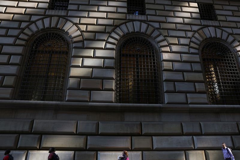 People walk by the Federal Reserve Bank of New York in the financial district of New York City, U.S., June 14, 2023.  REUTERS/Shannon Stapleton/File Photo