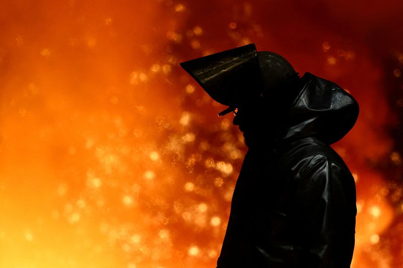 FILE PHOTO: A steel worker stands amid sparks of raw iron coming from a blast furnace at a ThyssenKrupp steel factory in Duisburg, Germany, November 5, 2025. REUTERS/Leon Kuegeler/File Photo