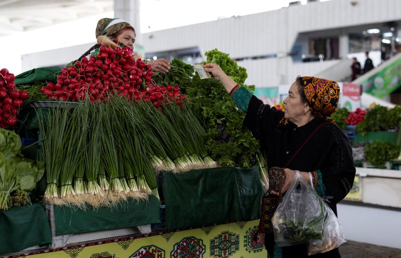 A woman buys vegetables at an open market in Ashgabat, Turkmenistan, March 17, 2026. REUTERS/Umit Bektas