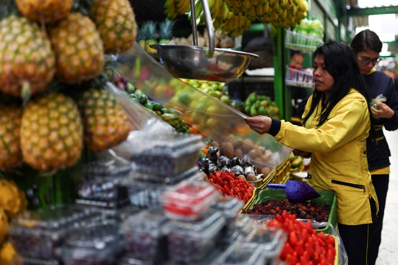 A person works at the Paloquemao market square, in Bogota, Colombia January 16, 2025. REUTERS/Luisa Gonzalez