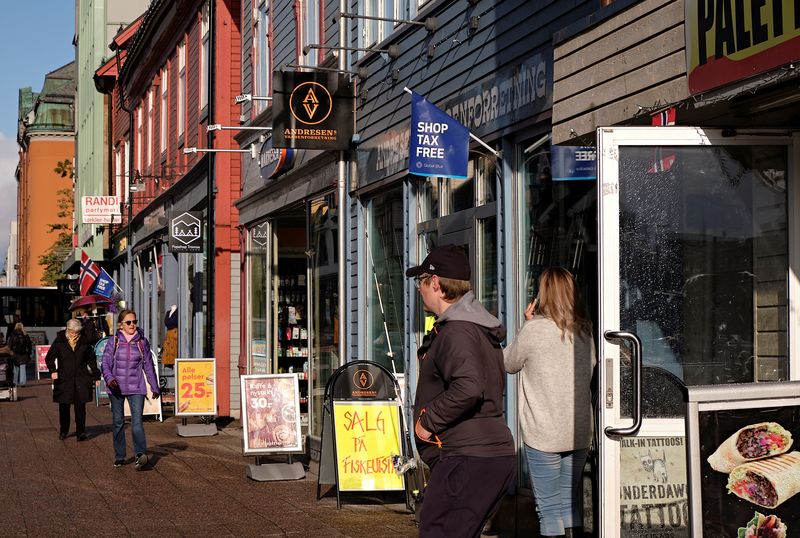 People walk past shops in Tromso, Norway September 19, 2019. REUTERS/Ints Kalnins