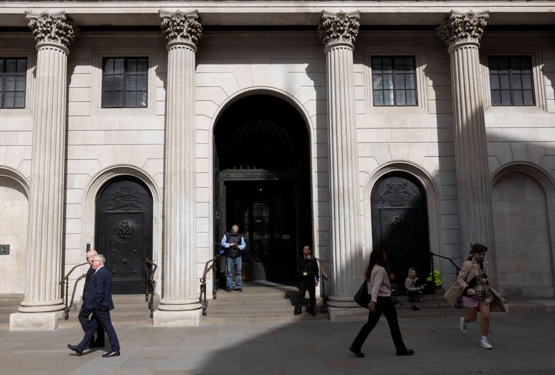 People walk outside the Bank of England building in London, Britain, April 14, 2025. REUTERS/Carlos Jasso