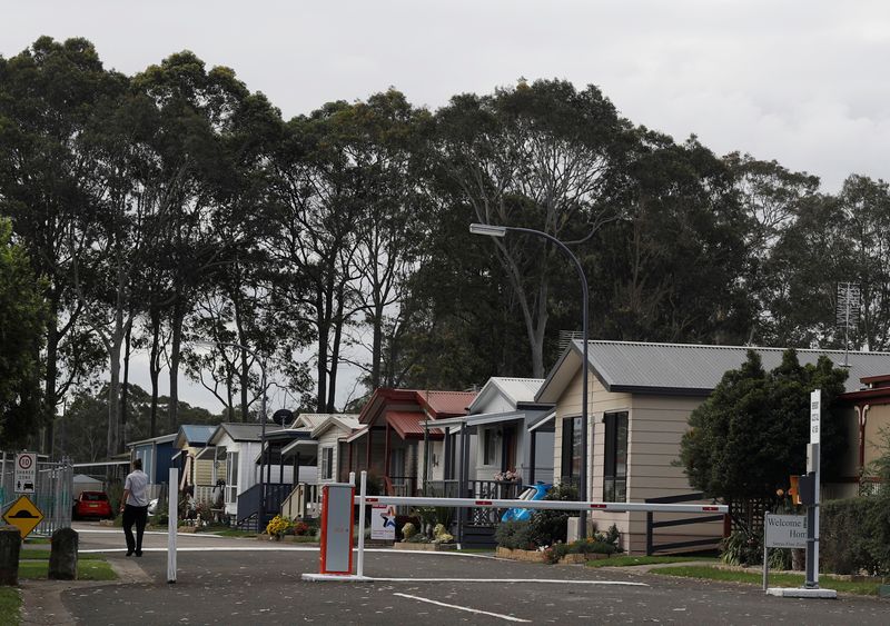 FILE PHOTO: A woman walk past houses in Nowra, Australia April 26, 2018. REUTERS/Edgar Su/File Photo