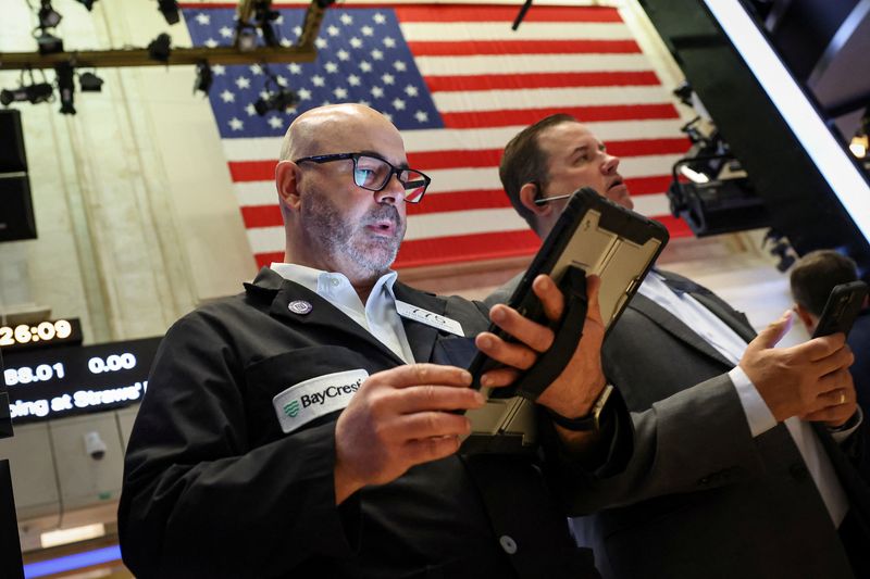 Traders work on the floor at the New York Stock Exchange (NYSE) in New York City, U.S., May 5, 2026.  REUTERS/Brendan McDermid/File Photo