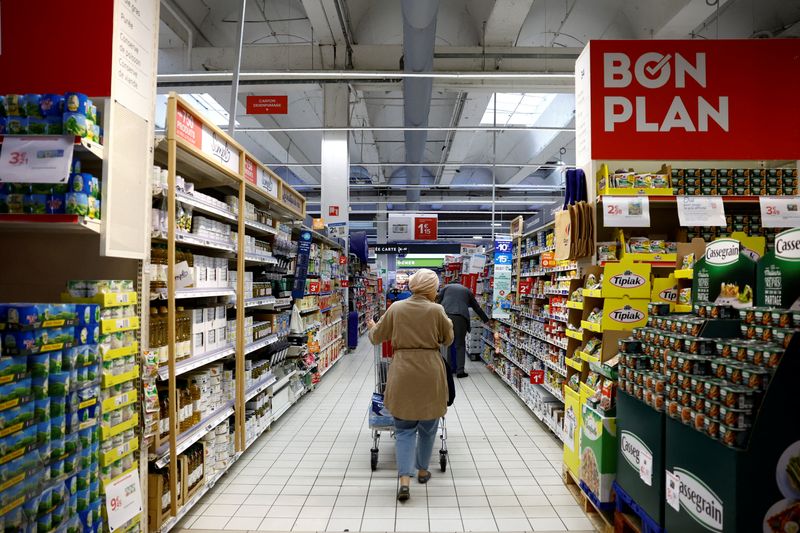 FILE PHOTO: A customer shops in a Carrefour supermarket in Montesson near Paris, France, September 13, 2023. REUTERS/Sarah Meyssonnier/File Photo