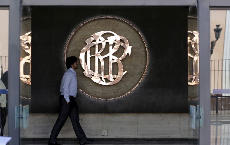 A man walks pasts the logo of the Central Reserve Bank of Peru's (BCRP) inside a building in downtown Lima, April 7, 2015. REUTERS/Mariana Bazo