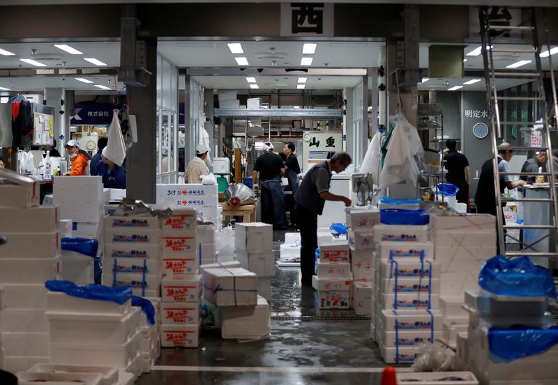 A fishmonger works at a wholesalers' area on the opening day of the new Toyosu fish market, which has been relocated from Tsukiji market, in Tokyo, Japan, October 11, 2018.   REUTERS/Issei Kato