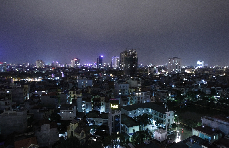 The skyline of Hanoi is seen from a building at night December 1, 2011. The country's population density is nearly 260 people for each square km, six times above the world's average, the local media said on Wednesday. REUTERS/Kham (VIETNAM - Tags: CITYSPACE SOCIETY)