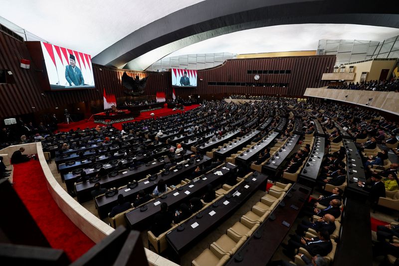 Large screens display Indonesian President Prabowo Subianto as he delivers his speech on economic policies and the 2027 fiscal plan to parliament members at the parliament building in Jakarta, Indonesia, May 20, 2026. REUTERS/Willy Kurniawan