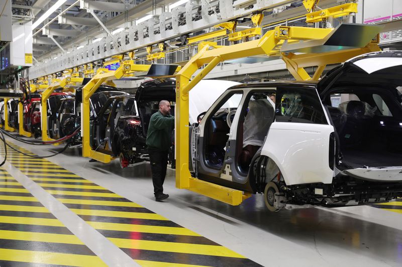 A member of staff works on the production line at Jaguar Land Rover’s factory in Solihull, Britain, December 15, 2022. REUTERS/Phil Noble