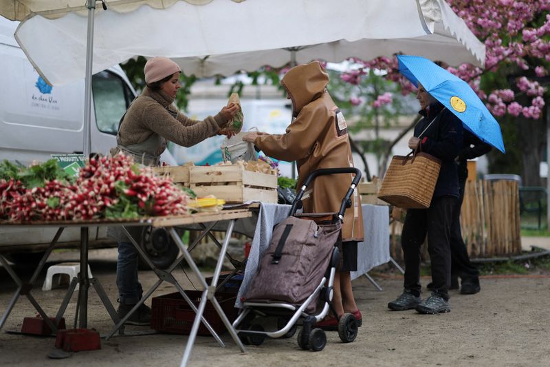 People shop at a local market in Nantes, France, April 3, 2026. REUTERS/Stephane Mahe