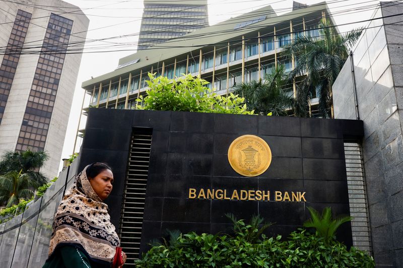 A woman passes by Bangladesh's central bank in Dhaka, Bangladesh, July 19, 2023. REUTERS/Mohammad Ponir Hossain