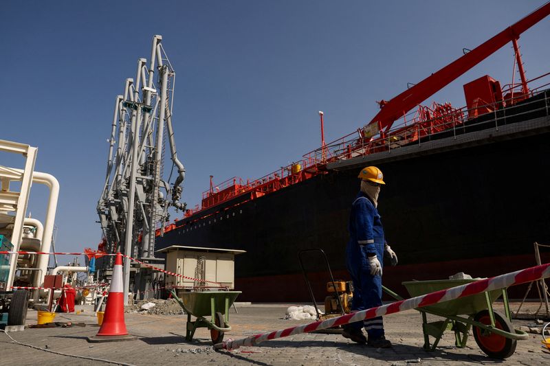 FILE PHOTO: A person works near an oil tanker docked at the Port of Fujairah, as the U.S.-Israel conflict with Iran limits marine traffic in the Strait of Hormuz, in Fujairah, United Arab Emirates, May 6, 2026. REUTERS/Amr Alfiky/File Photo