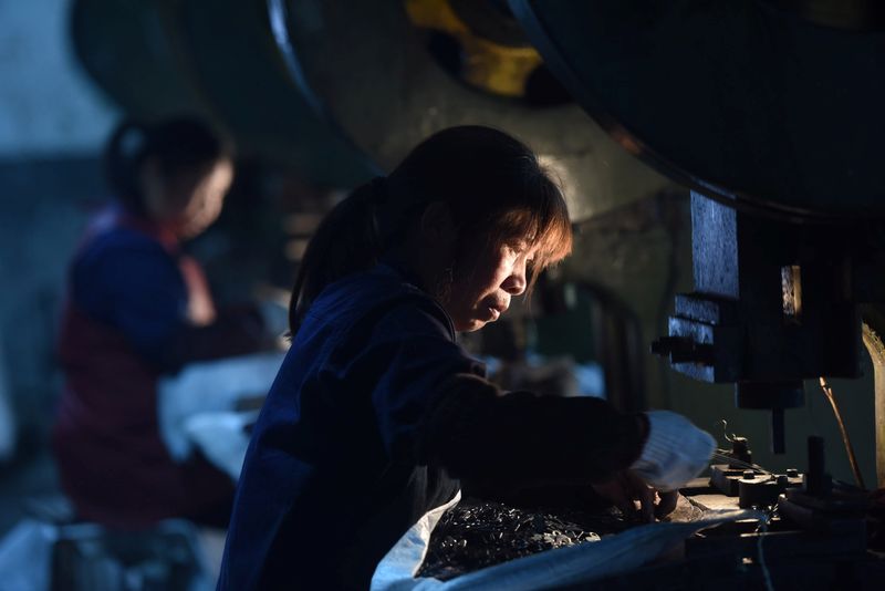 Employees work on a production line manufacturing metal parts for furniture at a factory in Hangzhou, Zhejiang province, China April 30, 2020. China Daily via REUTERS  ATTENTION EDITORS - THIS IMAGE WAS PROVIDED BY A THIRD PARTY. CHINA OUT.