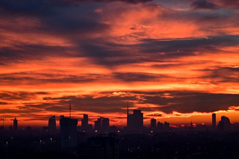 The Milan skyline at sunset with clouds illuminated over the city, in Milan, Italy, January 10, 2026. REUTERS/Daniele Mascolo