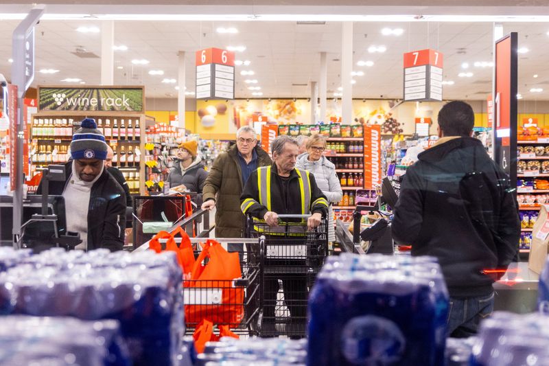 People shop in a grocery store in Mississauga, Ontario, Canada, January 26, 2026. REUTERS/Carlos Osorio