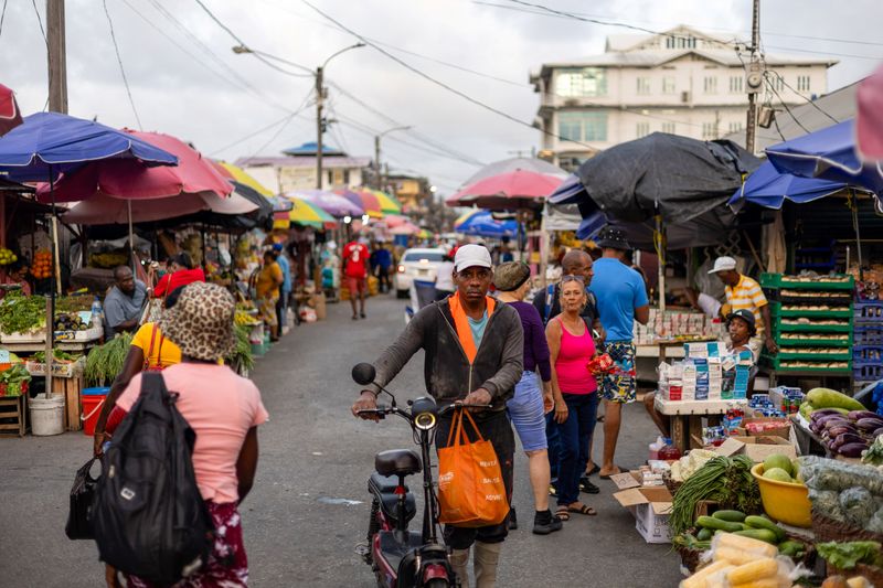 Shoppers walk through the downtown Bourda Market, as Guyana's fast-growing economy is set to benefit from a reshaped global energy market due to the U.S.-Israeli war on Iran, in Georgetown, Guyana May 9, 2026. REUTERS/Yancey Haywood