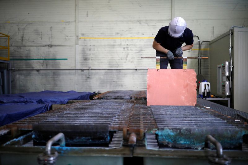 An employee holds a recycled copper plate at an urban mining plant in Gunsan, South Korea, April 2, 2018.   REUTERS/Kim Hong-Ji