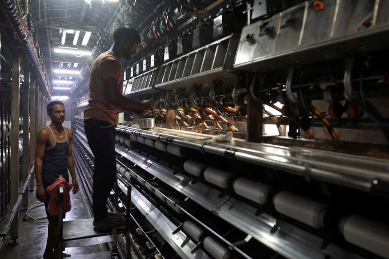 Employees work inside a polyester yarn manufacturing unit of Radheshyam Textiles at Pipodara, on the outskirts of Surat, Gujarat, April 16, 2026. REUTERS/Amit Dave