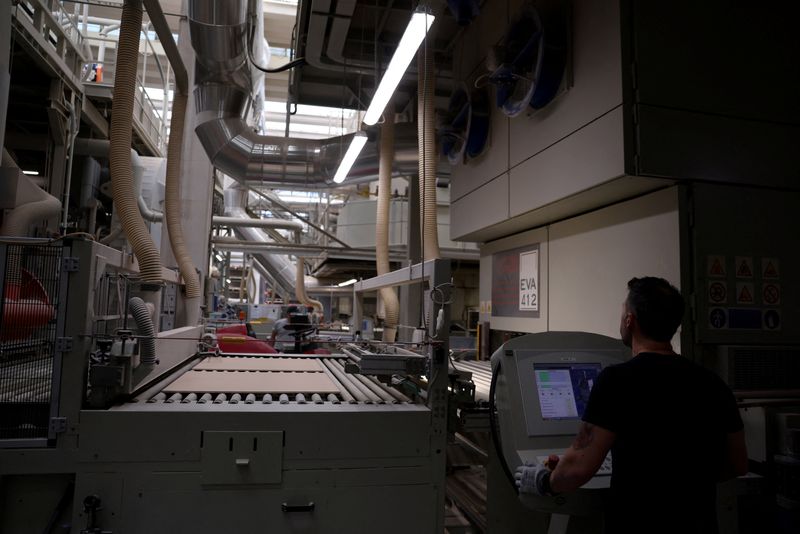 A worker looks on as tiles stand on conveyor rollers at Gruppo Romani ceramics factory production line. Italy's ceramic tile district of Sassuolo, responsible for more than 80% of national output, is among Europe's most energy‑intensive manufacturing hubs and increasingly exposed to turmoil in global energy markets as the Iran crisis deepens, in Rubiera, Italy, April 30, 2026. REUTERS/Claudia Greco