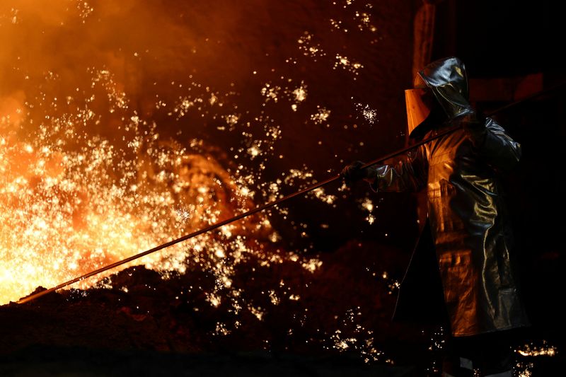 A steel worker stands amid sparks of raw iron coming from a blast furnace at a ThyssenKrupp steel factory in Duisburg, Germany, November 5, 2025. REUTERS/Leon Kuegeler
