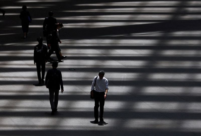 People walk through a convention hall in Tokyo, Japan, May 15, 2025.  REUTERS/Issei Kato