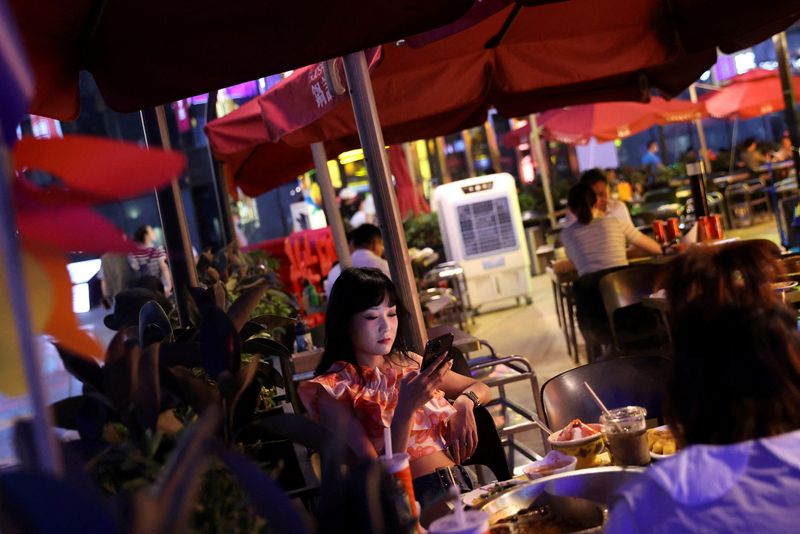 FILE PHOTO: Customers dine at a restaurant in a shopping area of Beijing, China July 25, 2022. REUTERS/Tingshu Wang/File Photo