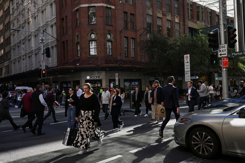 People cross the street in the Sydney Central Business District, in Sydney, Australia, May 14, 2024. REUTERS/Jaimi Joy