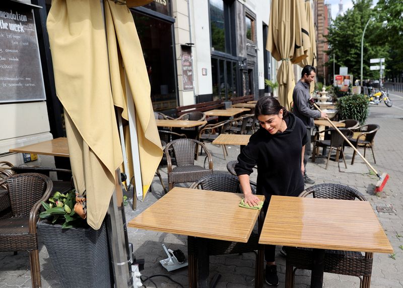 A staff member prepares for service at a restaurant in Berlin, Germany, May 13, 2020. REUTERS/Fabrizio Bensch