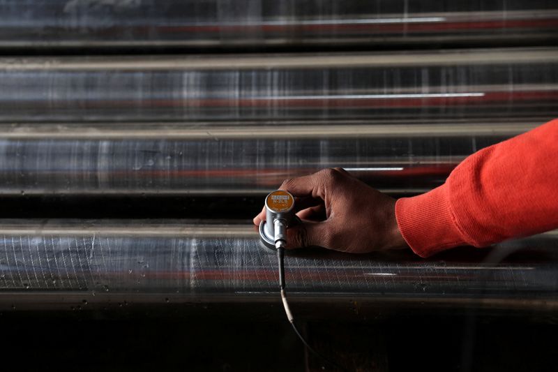 A worker checks for minor cracks on steel bars with an ultrasound machine, inside a steel factory on the outskirts of Ahmedabad, India, January 28, 2026. REUTERS/Amit Dave
