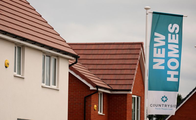 A banner advertising new houses for sale a seen on a new housing development under construction in Partington, Britain June 1, 2023. REUTERS/Phil Noble