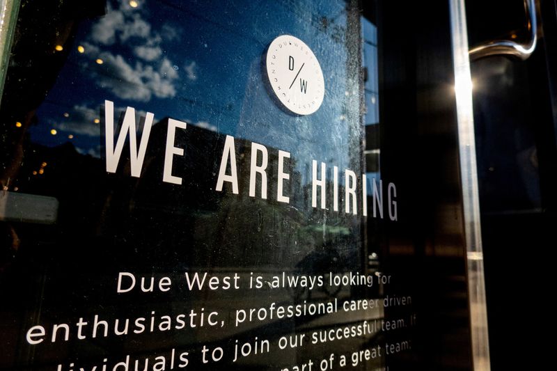 FILE PHOTO: A help wanted sign at a store along Queen Street West in Toronto Ontario, Canada June 10, 2022. REUTERS/Carlos Osorio/File Photo