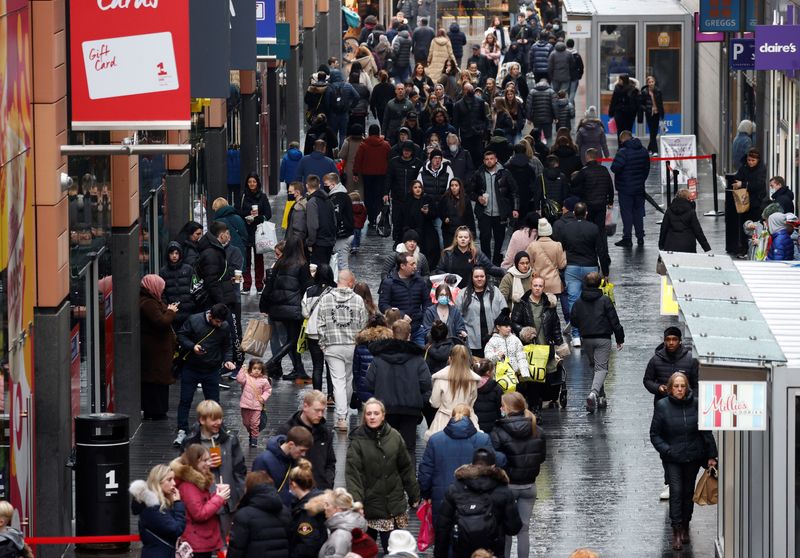 People walk along a busy shopping street in Liverpool, Britain, December 26 , 2021. REUTERS/Phil Noble